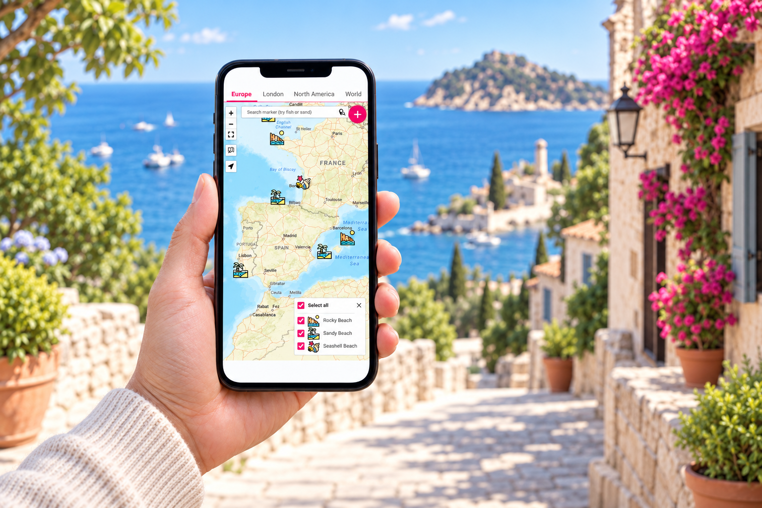 A hand holding a smartphone with Open User Map against a Mediterranean coastal landscape